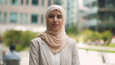 Portrait-Of-Muslim-Businesswoman-Outdoors-Standing-In-Front-Of-City-Offices